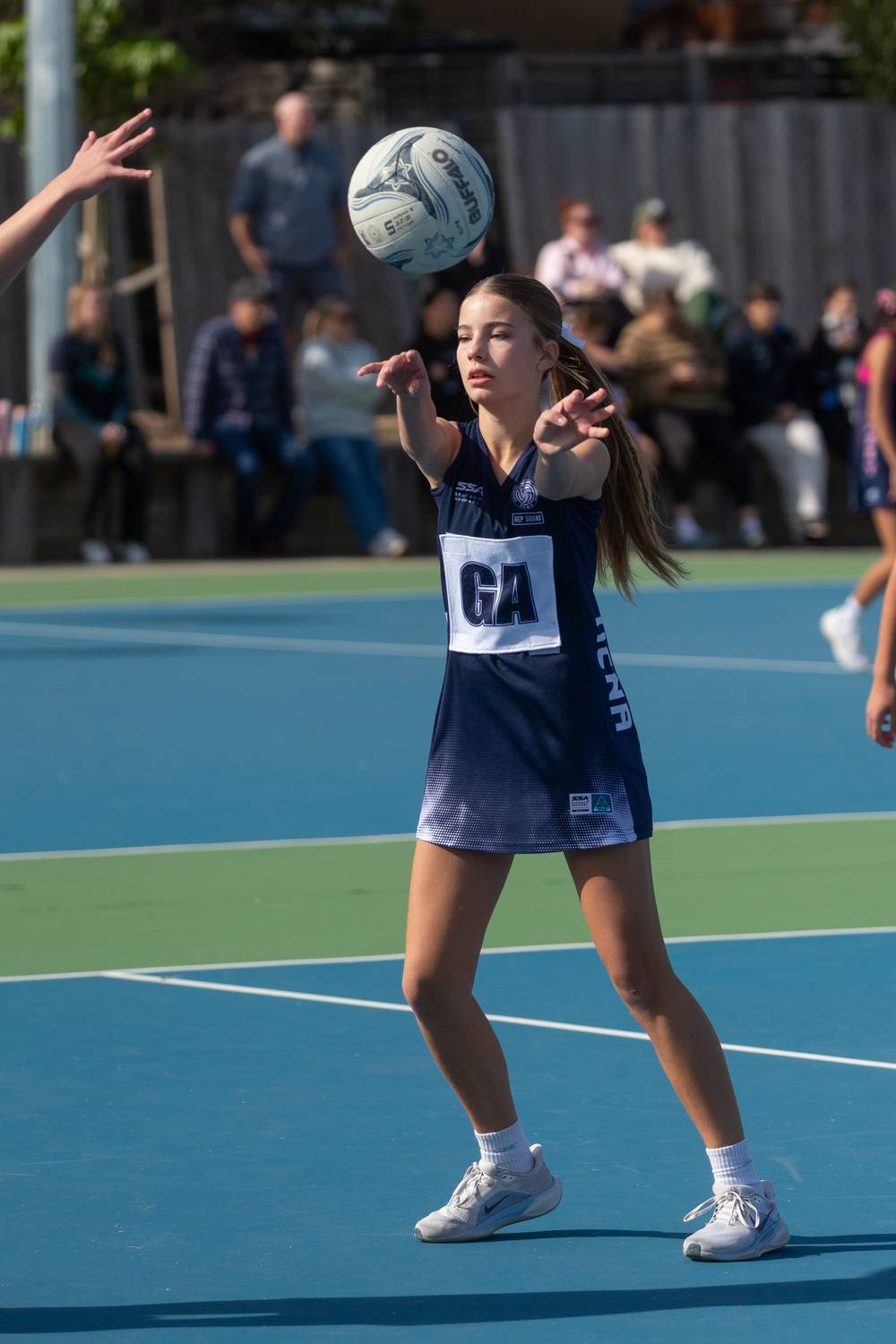 Junior player releasing a pass during a representative match